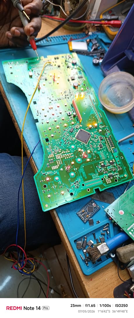 Repaired electronic control board prepared for testing and connector checks